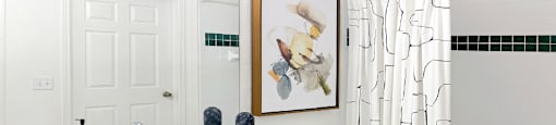 Spacious bright white bathroom with oversized garden tub and built-in vanity at Village on the Parkway Apartments