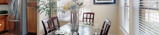 Luxury apartments in Houston with spacious kitchen and dining room with granite countertops, kitchen island, stainless steel appliances, oversized windows, lots of natural light, and hardwood floors.