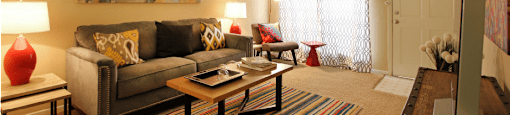 Spacious one and two bedroom floor plans with white brick accent walls at Waters of Winrock Apartments in Houston.