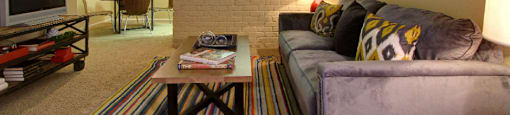 Spacious one and two bedroom floor plans with white brick accent walls at Waters of Winrock Apartments in Houston.