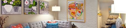 Spacious one and two bedroom floor plans with white brick accent walls and wood plank floors at Waters of Winrock Apartments in Houston.