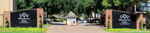 Gated apartments with 2 swimming pools, convenient bayou location, lush landscaping, and scenic views at Woodlake Oaks Apartments in Houston.