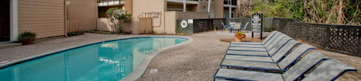 Gated apartments with 2 swimming pools, convenient bayou location, lush landscaping, and scenic views at Woodlake Oaks Apartments in Houston.