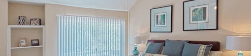 Huge master bedroom with vaulted ceiling, built-in shelves, attached master bathroom and walk-in closet at Woodlake on the Bayou Apartments in Houston.