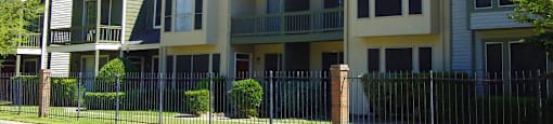 Gated apartment community with 4 swimming pools, convenient bayou location only minutes away from shopping and dining and scenic views at Woodlake on the Bayou Apartments in Houston.