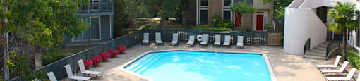 Gated apartments with 4 swimming pools, convenient bayou location, lush landscaping and scenic views at Woodlake on the Bayou Apartments in Houston.