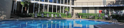 Gated apartments with 4 swimming pools, convenient bayou location, lush landscaping and scenic views at Woodlake on the Bayou Apartments in Houston.