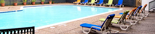 Gated apartments with 4 swimming pools, convenient bayou location, lush landscaping and scenic views at Woodlake on the Bayou Apartments in Houston.