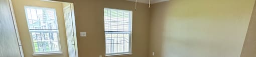 A room with wooden floors and a ceiling fan.