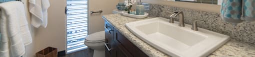 Waikiki Walina Apartments bathroom sink, vanity, and toilet
