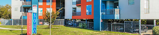 a blue and red building with flags in front of it