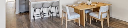 a dining room and kitchen with a table and chairs