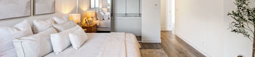 a bedroom with a large bed and a ceiling fan