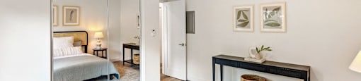 a bedroom with a bed and a ceiling fan