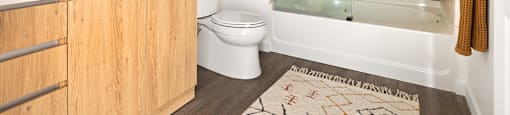 A bathroom with a toilet, sink, and shower.