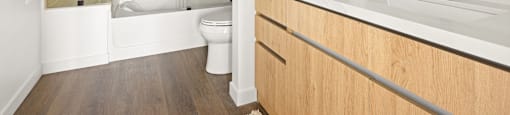 A modern bathroom with a glass shower and a white toilet.