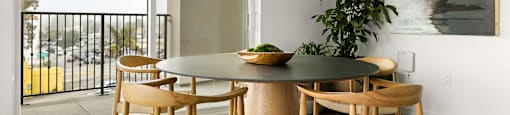 A dining room with a table and chairs.