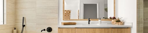 A bathroom with a tub, sink, and mirror.