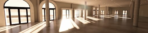 a large empty room with sunlight coming through the windows