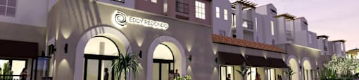 A modern building with a large arched entrance and the name "EDDY PEDIGON" on the facade.