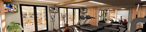 A man in a red shirt is working out in a gym with various exercise equipment.