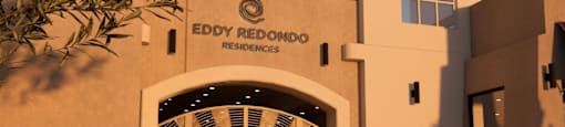 A building with the sign "EDDY REDONDO RESIDENCES" is shown with a patio area in front.