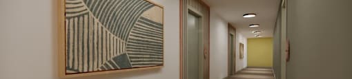 A hallway with a painting on the wall and doors on the right.