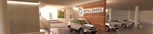 A car dealership with a sign that says "Retail Shops" and several cars on display.