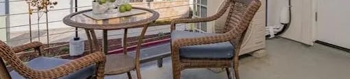 a balcony with a table and chairs on it