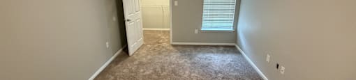 Park at Kirkstall 1-bed bedroom with a carpeted floor and a ceiling fan.