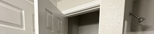 Park at Kirkstall 1-bed bathroom closet with shelves.