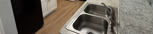 Park at Kirkstall 2-bed kitchen with black appliances and white cabinets.