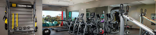 A gym with a variety of equipment including weights and exercise balls.
