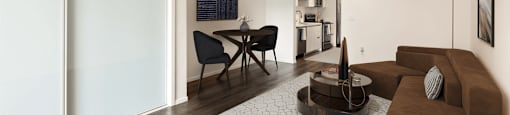 A modern living room with a brown couch and a coffee table.