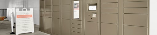 A wall of lockers with a sign on the floor.