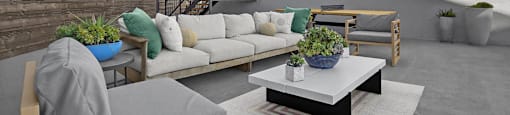 A modern outdoor seating area with a couch, chairs, and a coffee table.