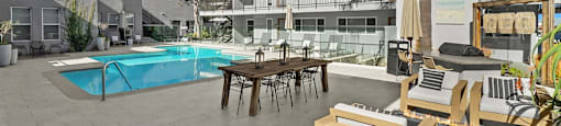 A poolside area with a table and chairs.