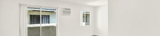 A room with a wooden floor and a doorway leading to a balcony at Bonnie Brae Apartments, California, 90006