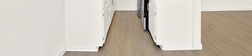 A kitchen with white appliances and cabinets at Bonnie Brae Apartments, Los Angeles, CA, 90006