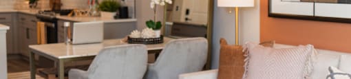 a living room and dining room with a couch and a table at The Yards at Malvern, Malvern, PA