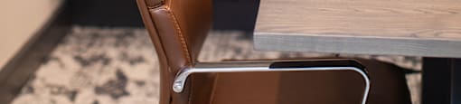 a leather chair sitting next to a wooden table in a room at The Yards at Malvern, Malvern, PA