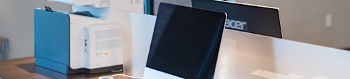 a desk with a laptop and a stack of books at The Yards at Malvern, Malvern, PA