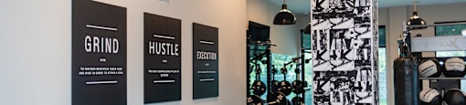 a gym with a variety of machines and posters on the wall at The Yards at Malvern, Malvern, PA