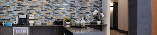 a kitchen with a marble counter and a fish wallpaper on the wall at The Yards at Malvern, Malvern, PA