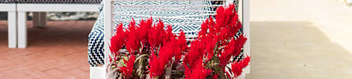 a patio with a couch and a vase of red flowers at The Yards at Malvern, Malvern, PA