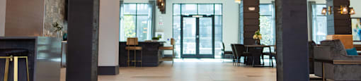 the lobby of a hotel with a marble floor and a fireplace at The Yards at Malvern, Malvern, PA