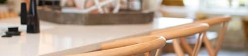 a row of wooden bar stools at a kitchen counter at The Yards at Malvern, Malvern, PA