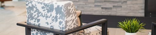 a chair in front of a fireplace in a lobby at The Yards at Malvern, Malvern, PA