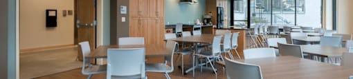 A conference room with a long table and chairs.