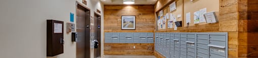 A long hallway with a wood panelled wall and metal lockers.
